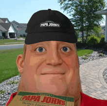 a man wearing a papa john 's hat is holding a box of papa john 's pizza