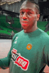 a man wearing a green shirt that says euroleague