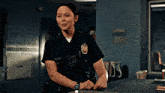 a woman in a police uniform is standing in front of a desk
