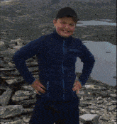 a young boy wearing a blue columbia jacket