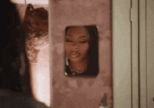 a woman is looking at herself in a mirror in a closet .