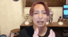 a young man with red hair is making a funny face