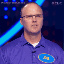a man with glasses and a name tag that says joel on it