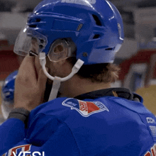 a hockey player wearing a blue jersey with the word rangers on it