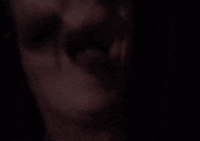 a close up of a person 's face with a piercing in their mouth .