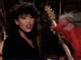 a woman is surrounded by stuffed animals and a sign that says elmo