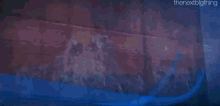a blurry picture of a building with graffiti on it and the words the next big thing on the bottom