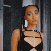 a woman in a braided ponytail is wearing a black bra top