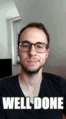 a man wearing glasses and a black shirt has the words well done on his face