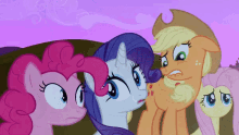 a group of ponies are standing next to each other looking at something