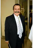 a man in a suit and tie with a mustache