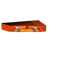 a stack of orange judo club armbands with cartoon characters on them