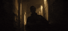 a man in a dark room with a ny logo on his sweatshirt