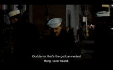 a man in a navy hat says goddamn that 's the goddamndest thing i ever heard