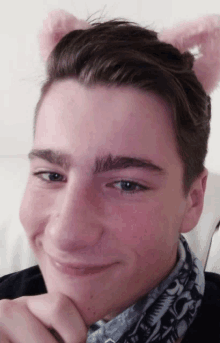 a young man wearing a pair of pink bunny ears