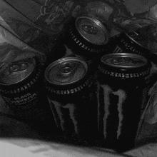 several cans of black monster energy drink