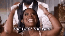 a woman is sitting next to a man in a tuxedo and holding her head .
