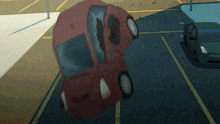 a red car with a broken windshield is laying on its side in a parking lot
