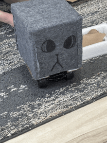 a cube with a cat face drawn on it