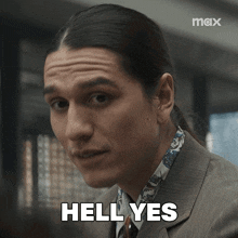 a man with long hair says hell yes