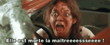 a woman in a car with blood on her face is screaming in a foreign language .