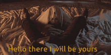 a man and woman are laying under a blanket with the words hello there i will be yours below them