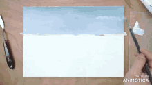a person is painting on a canvas with the words made in animotica visible