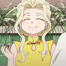 a woman with blonde hair and a yellow shirt is smiling
