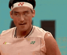 a man wearing a headband that says yonex