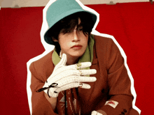 a man wearing a hat and gloves has a starbucks lanyard around his waist