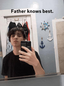 a young man takes a selfie in front of a mirror with the caption father knows best