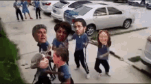 a group of people are dancing in a parking lot with their faces on their shirts .