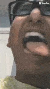 a close up of a man 's face with his tongue out .