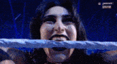a close up of a woman 's face with a rope around her mouth .