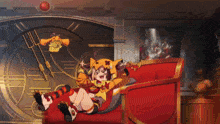 a girl in a cat costume is laying on a red chair