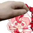 a person is putting a donut on top of a cartoon girl with hearts on her face .