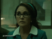 a woman wearing glasses and a headband has the hashtag lialmeida05 on the bottom