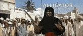 a man is holding a bat in front of a crowd of people and the word alligator is written above him .