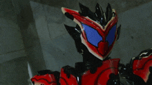 a person is standing in a dark room with a red item on the wall