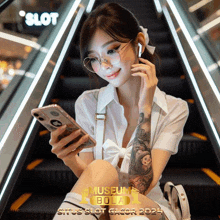 a woman is sitting on an escalator looking at her phone with a slot logo in the background