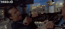 a man is holding a knife and another man is holding a boot with the words veed.io written on the bottom
