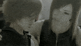 a black and white photo of a girl and a boy