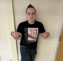 a boy wearing a brooklyn aero ny t-shirt