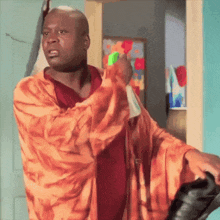 a man in a robe is holding a spray bottle in his hand