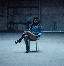 a woman in a police uniform is sitting in a chair