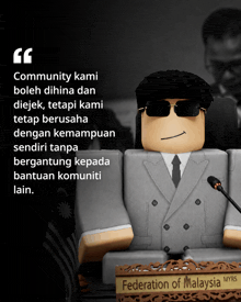a statue of a man in a suit and tie sits in front of a sign for the federation of malaysia