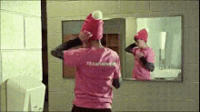 a person wearing a pink shirt that says ' team usa ' on it