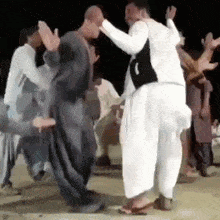 a group of men are dancing together and one of them is wearing a black vest with the number 1 on it .
