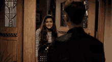 a man and a girl are standing in front of a door