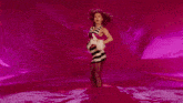 a woman with red hair is wearing a striped top that says " i love you "